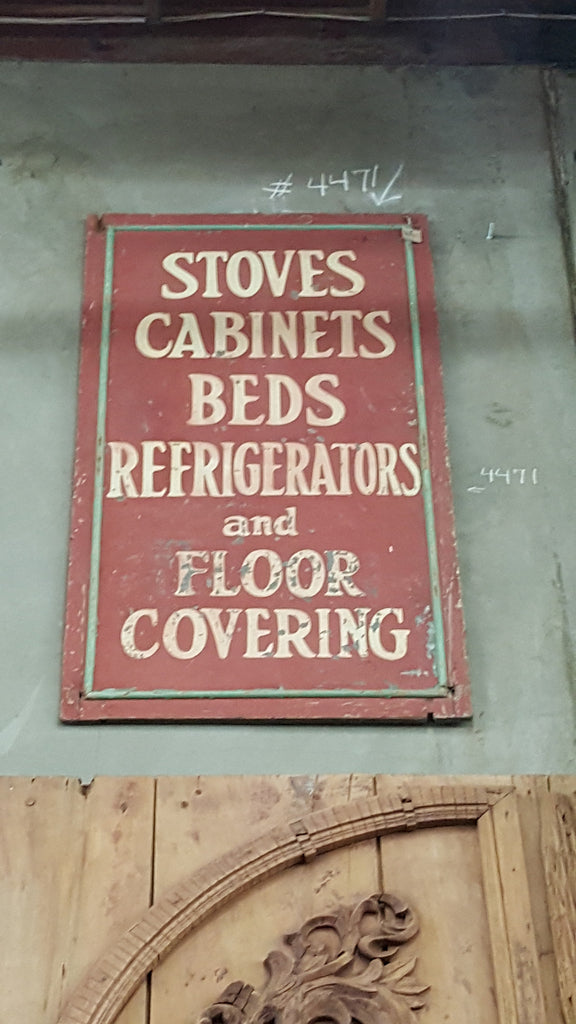 Red "Stoves Cabinets Beds Refrigerators and Floor Covering" Sign